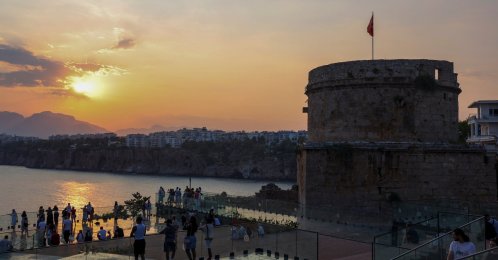 Visitors watch the sunset from the viewing terrace at the restored Hıdırlık Tower archaeological site, Antalya, Türkiye, July 21, 2026. (IHA Photo)