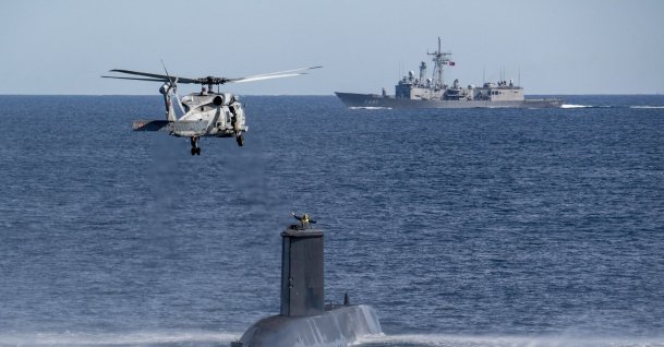 A Turkish naval helicopter, ship and submarine take part in a warfare exercise off the coast of Catania, Sicily, southern Italy,  Feb. 26, 2024. (AP Photo)