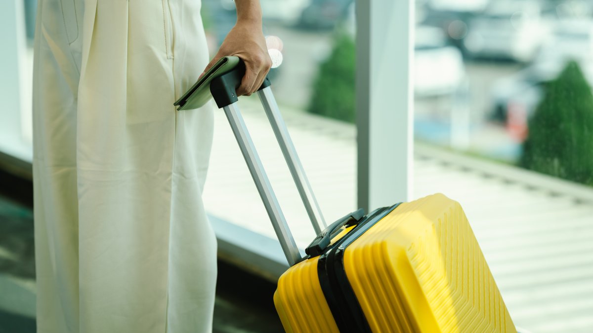A woman carries her luggage during travel. (Shutterstock Photo)