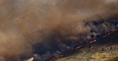 A wall of flames advances as a wildfire burns near Burgohondo, Avila province, Spain, July 23, 2026. (AP Photo)
