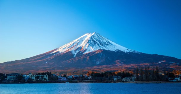 Snow covers the summit of Mount Fuji as seen from Lake Kawaguchi, Japan. (Shutterstock Photo)