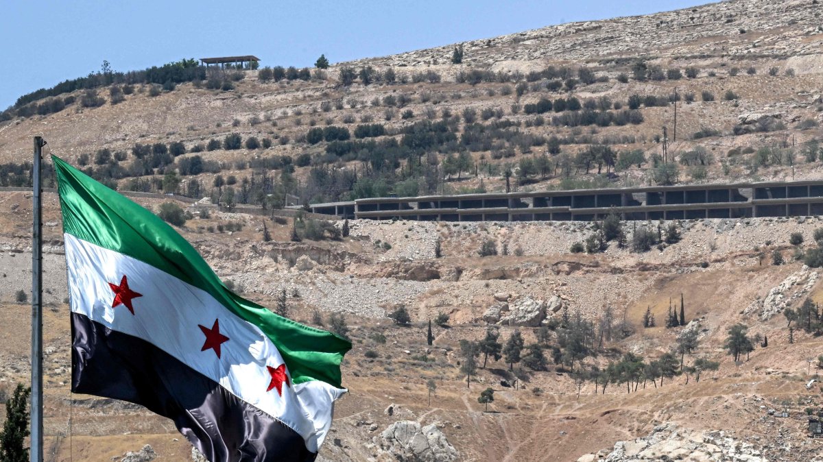 The Syrian flag flies at the Umayyad Square with Mount Qasioun pictured in the background, Damascus, Syria, July 22, 2026. (AFP Photo)