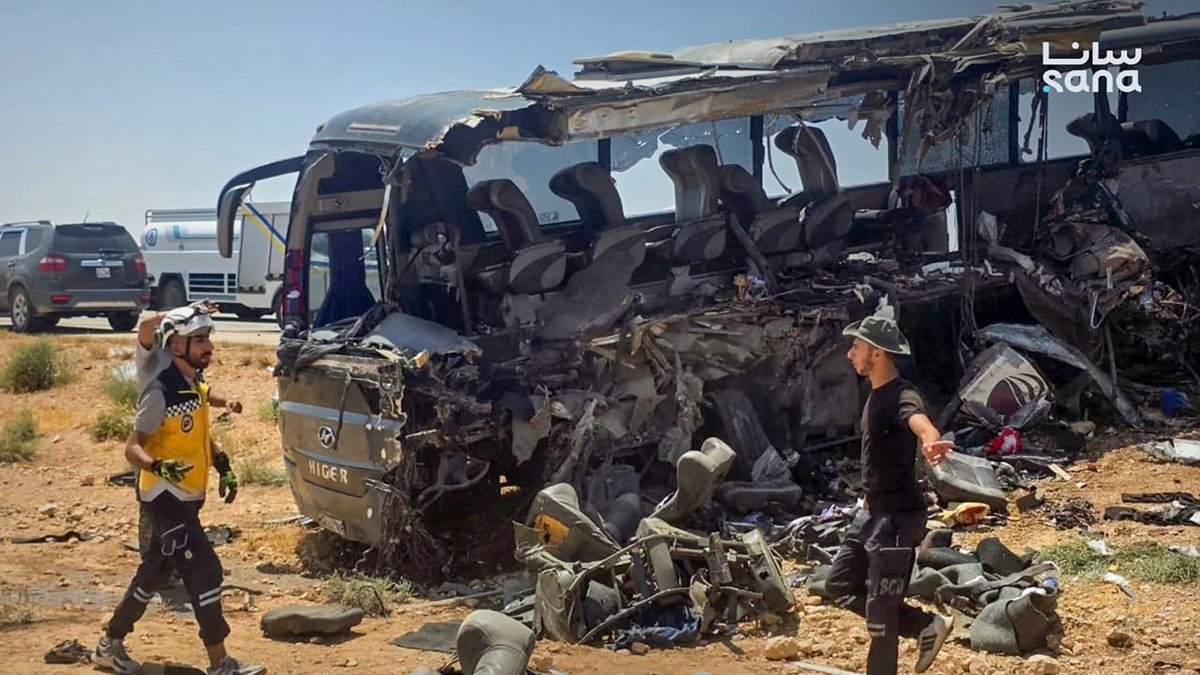 This handout picture taken and released by the official Syrian Arab News Agency (SANA)  shows people and first responders inspecting the damage at the scene of the collision of two passenger buses on the Damascus-Deir Ezzor road between the Sukhna and Palmyra areas, Syria, July 25, 2026. (AFP Photo)