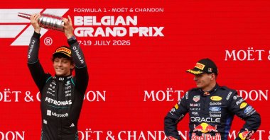 Mercedes' Andrea Kimi Antonelli (L) celebrates on the podium with third-place Red Bull driver Max Verstappen after winning the Formula One Grand Prix at the Spa-Francorchamps racetrack, Spa, Belgium, July 19, 2026. (AP Photo)