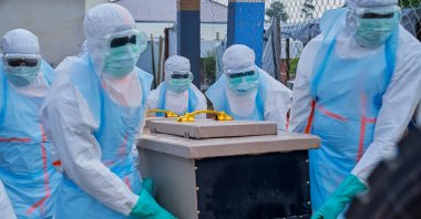 Staff lift a coffin into a vehicle at the Ebola treatment center of the General Hospital, Bunia, DRC, July 22, 2026. (EPA Photo)