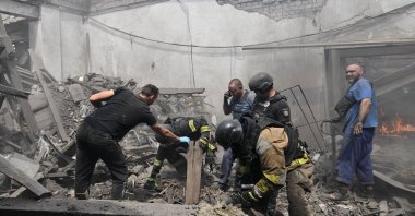 Rescuers and employers work at a site of the drinking water delivery company hit by a Russian air strike, amid Russia's attack on Ukraine, Zaporizhzhia, Ukraine, July 25, 2026. (Reuters Photo)