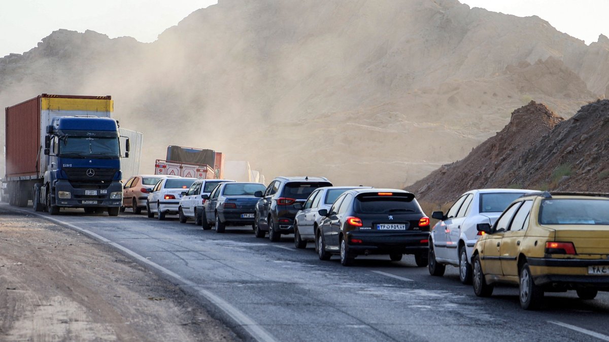 Vehicles wait in traffic near a heavily damaged bridge that was hit by a U.S. strike along the road connecting Roudan and Bandar Abbas in southern Iran, July 18, 2026. (AFP Photo)