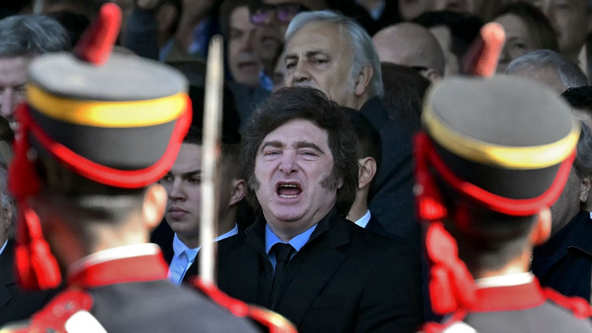 Argentina's President Javier Milei and Economy Minister Luis Caputo sing the San Lorenzo march during a parade of Argentine soldiers of the General San Martin Grenadier Regiment at the 138th annual La Rural agricultural exhibition in Buenos Aires, July 26, 2026. (AFP Photo)