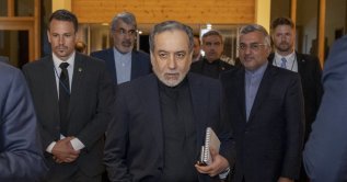 Iran's Minister of Foreign Affairs Seyyed Abbas Araghchi (C) arrives at the Burgenstock resort in Obbuergen, near Lucerne on June 21, 2026. (AFP File Photo)