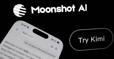 The logo of Chinese company Moonshot AI is displayed alongside its Kimi app on a mobile phone in this illustration picture, July 24, 2026. (Reuters Photo)