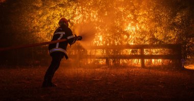 A firefighting crew battles a wildfire spreading in Ares, south-western France, July 25, 2026. (EPA Photo)