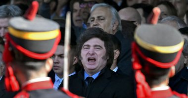 Argentina's President Javier Milei and Economy Minister Luis Caputo sing the San Lorenzo march during a parade of Argentine soldiers of the General San Martin Grenadier Regiment at the 138th annual La Rural agricultural exhibition in Buenos Aires, July 26, 2026. (AFP Photo)