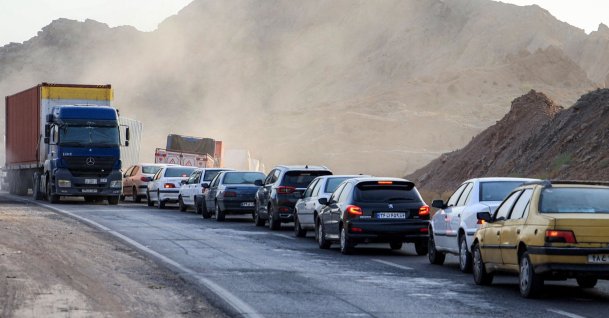 Vehicles wait in traffic near a heavily damaged bridge that was hit by a U.S. strike along the road connecting Roudan and Bandar Abbas in southern Iran, July 18, 2026. (AFP Photo)