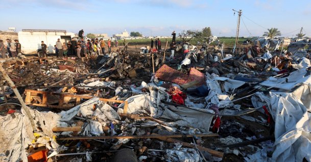 Palestinians inspect the site of an Israeli strike on a tent camp sheltering displaced people, who were warned to evacuate before the attack, in Khan Younis, in the southern Gaza Strip, June 30, 2026. (Reuters Photo)