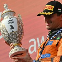 McLaren's British driver Lando Norris celebrates with the trophy after winning the Formula 1 Hungarian Grand Prix at the Hungaroring racetrack in Mogyorod near Budapest, Hungary, July 26, 2026. (AFP Photo)