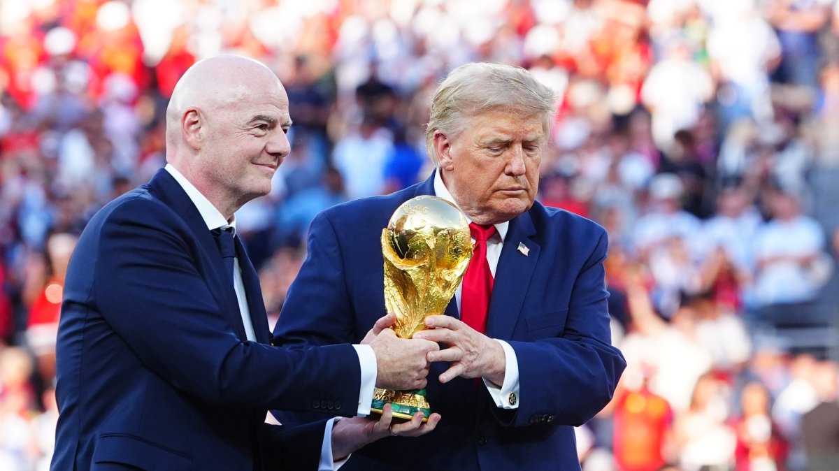 FIFA President Gianni Infantino (L) and U.S. President Donald Trump hold the World Cup trophy during the award ceremony for the final between Argentina and Spain, July 19, 2026. (AA Photo)