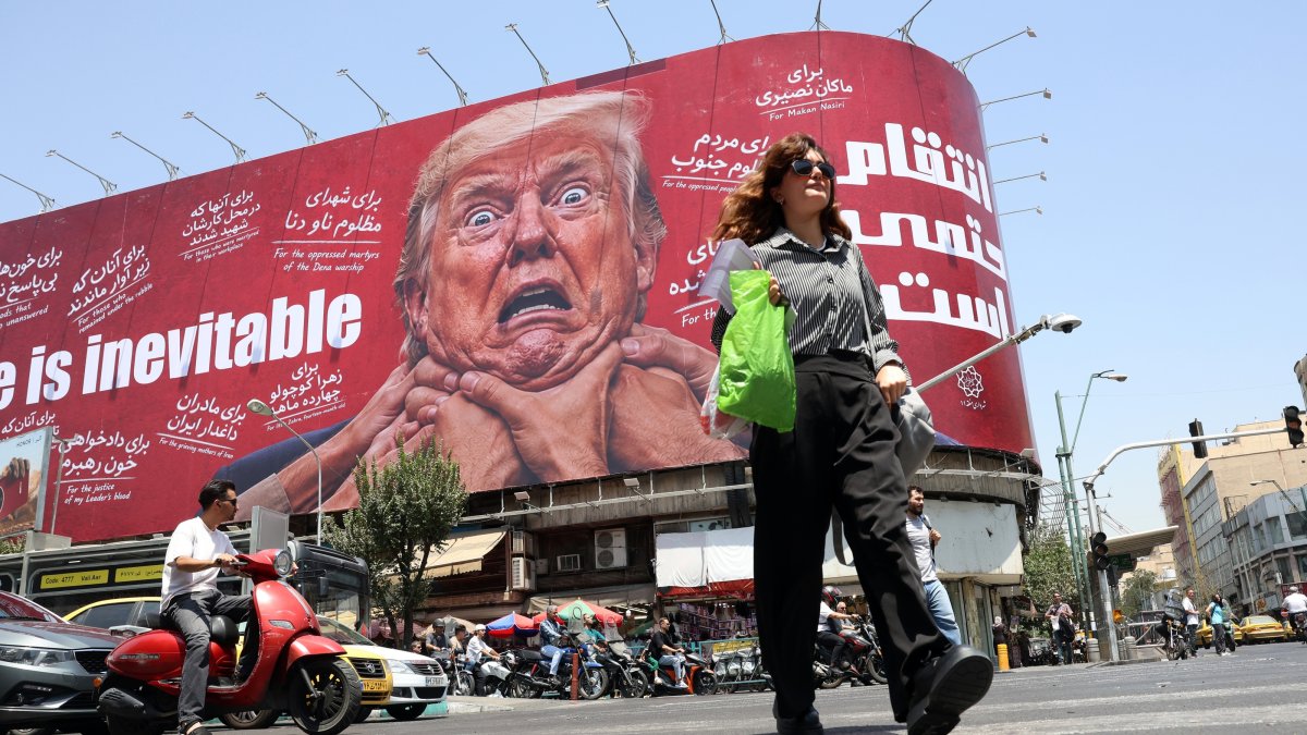A woman walks past an anti-U.S. billboard in Tehran, Iran, July 27, 2026. (EPA Photo)