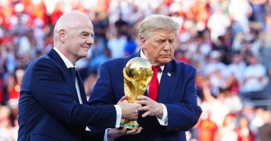 FIFA President Gianni Infantino (L) and U.S. President Donald Trump hold the World Cup trophy during the award ceremony for the final between Argentina and Spain, July 19, 2026. (AA Photo)