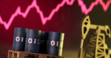 A 3D-printed oil pump jack and barrels in front of a rising stock graph appear in this illustration, taken March 2, 2026. (Reuters Photo)
