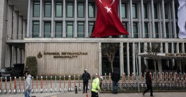 People walk in front of the Istanbul Metropolitan Municipality (IBB) headquarters, Istanbul, Türkiye, March 19, 2025. (Getty Images Photo)