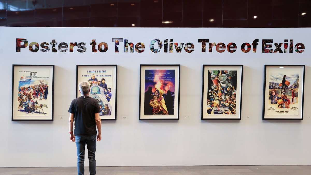 A visitor views Turkish artist Ahmet Yusuf Aygeç's exhibition, "Posters for the Olive Tree in Exile," at the Mahmoud Darwish Museum in Ramallah, the occupied West Bank, Palestine, July 26, 2026. (AA Photo)