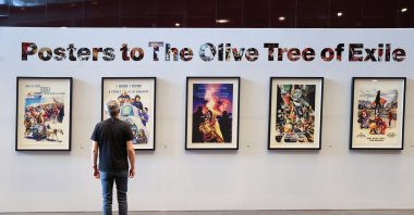 A visitor views Turkish artist Ahmet Yusuf Aygeç's exhibition, "Posters for the Olive Tree in Exile," at the Mahmoud Darwish Museum in Ramallah, the occupied West Bank, Palestine, July 26, 2026. (AA Photo)