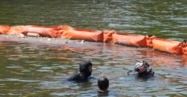 Participants take part in a dive during an environmental awareness event highlighting pollution in Istanbul's Golden Horn, Istanbul, Türkiye, July 28, 2026. (IHA Photo)