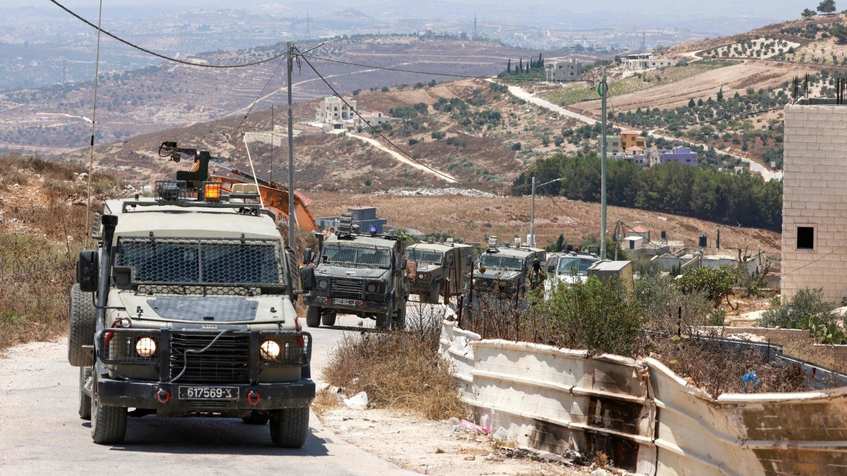 Israeli soldiers in their vehicles patrol the road in the Palestinian village of Tell, in the Israeli-occupied West Bank, July 25, 2026. (AFP Photo)
