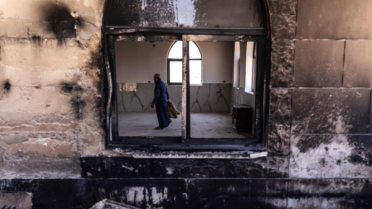 A Palestinian man prepares to pray at a mosque allegedly burned by Israeli settlers in the village of Qusra, south of Nablus in the Israeli-occupied West Bank, July 26, 2026. (AFP Photo)