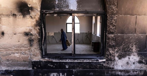 A Palestinian man prepares to pray at a mosque allegedly burned by Israeli settlers in the village of Qusra, south of Nablus in the Israeli-occupied West Bank, July 26, 2026. (AFP Photo)