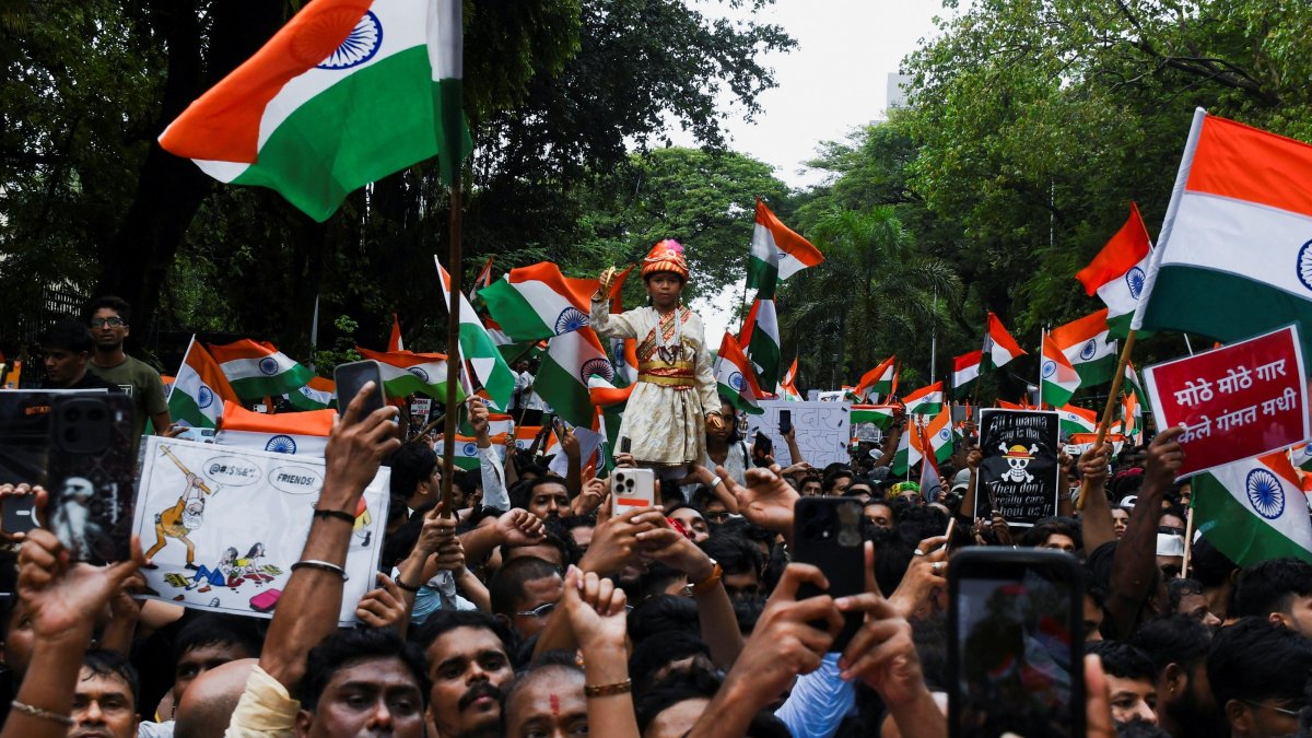 Cockroach Janta Party (CJP) supporters chant slogans, hold placards and wave national flag as they celebrate the resignation of Education Minister Dharmendra Pradhan over the National Eligibility cum Entrance Test (NEET) examination paper leaks, Mumbai, India, July 26, 2026. (Reuters Photo)