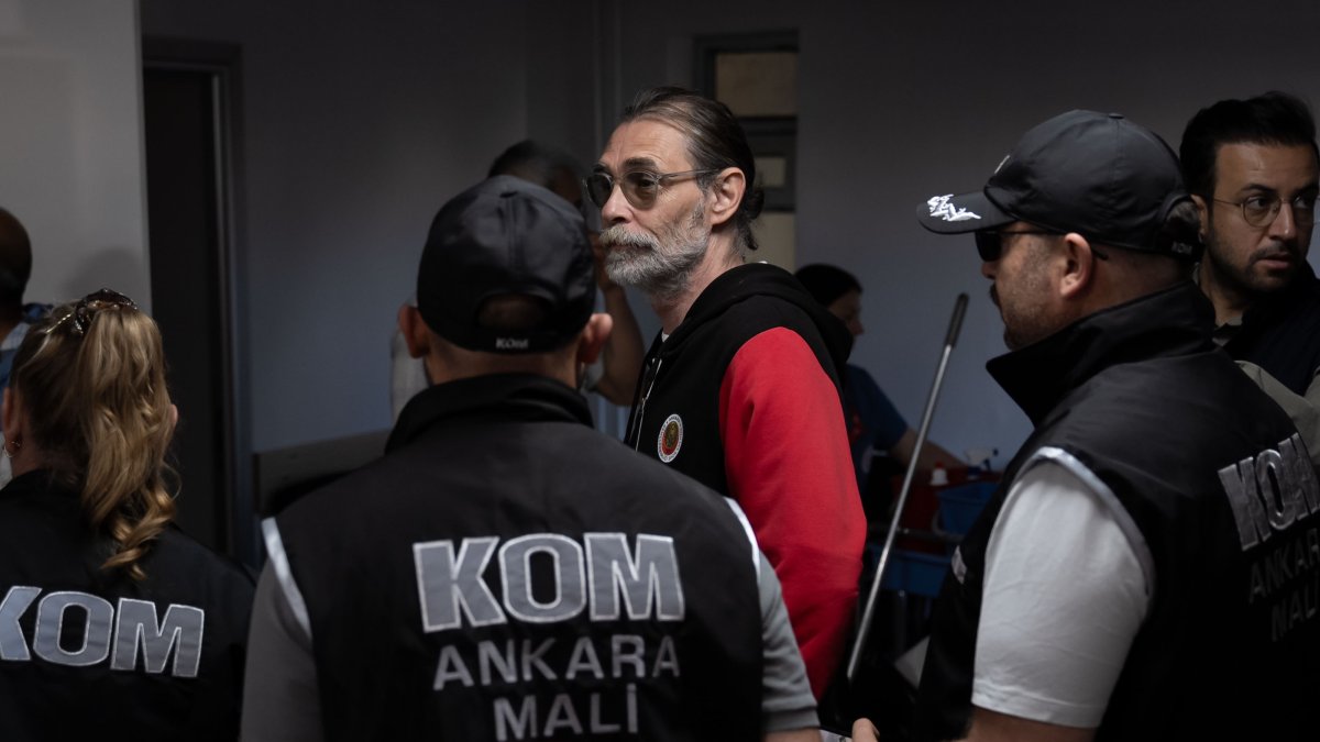 Police officers escort Erdal Beşikçioğlu after his detention, Ankara, Türkiye, July 30, 2026. (AA Photo)