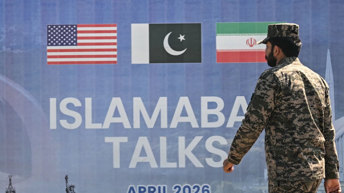 A Pakistani Ranger walks past a billboard for the U.S.-Iran peace talks in Islamabad, Pakistan, April 12, 2026. (AFP Photo)