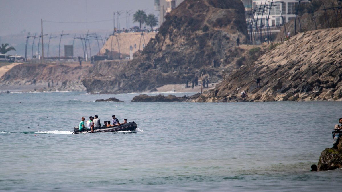 Migrants try to cross into the Spanish enclave of Ceuta aboard a boat off the coast of Morocco, July 30, 2026. (AP Photo)