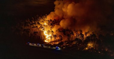 A firefighter crew battles a fire near Le Porge, southwestern France, July 29, 2026. (EPA Photo)