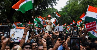 Cockroach Janta Party (CJP) supporters chant slogans, hold placards and wave national flag as they celebrate the resignation of Education Minister Dharmendra Pradhan over the National Eligibility cum Entrance Test (NEET) examination paper leaks, Mumbai, India, July 26, 2026. (Reuters Photo)