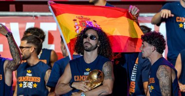 Spain's Marc Cucurella (C) holds the World Cup trophy during the 2026 FIFA World Cup victory celebration parade, Madrid, Spain, July 20, 2026. (AA Photo)