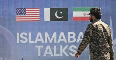 A Pakistani Ranger walks past a billboard for the U.S.-Iran peace talks in Islamabad, Pakistan, April 12, 2026. (AFP Photo)