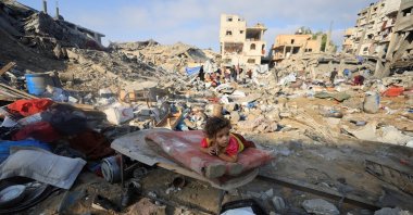 A Palestinian child lies on a damaged mattress at the site of an Israeli strike in Gaza City, Palestine, July 30, 2026. (Reuters Photo)