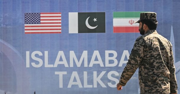 A Pakistani Ranger walks past a billboard for the U.S.-Iran peace talks in Islamabad, Pakistan, April 12, 2026. (AFP Photo)
