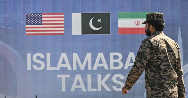 A Pakistani Ranger walks past a billboard for the U.S.-Iran peace talks in Islamabad, Pakistan, April 12, 2026. (AFP Photo)