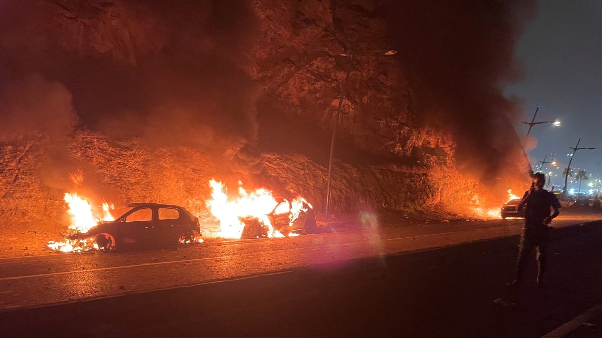 Vehicles burn as migrants wait for a chance to cross to the Spanish enclave of Ceuta, Fnideq, Morocco, July 31, 2026. (Reuters Photo)