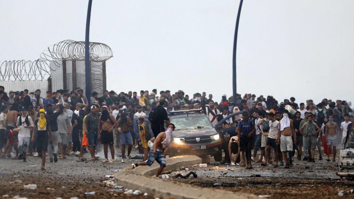 People gather at the site of clashes near Fnideq, on the Morocco-Spain border, July 31, 2026. (AFP Photo)