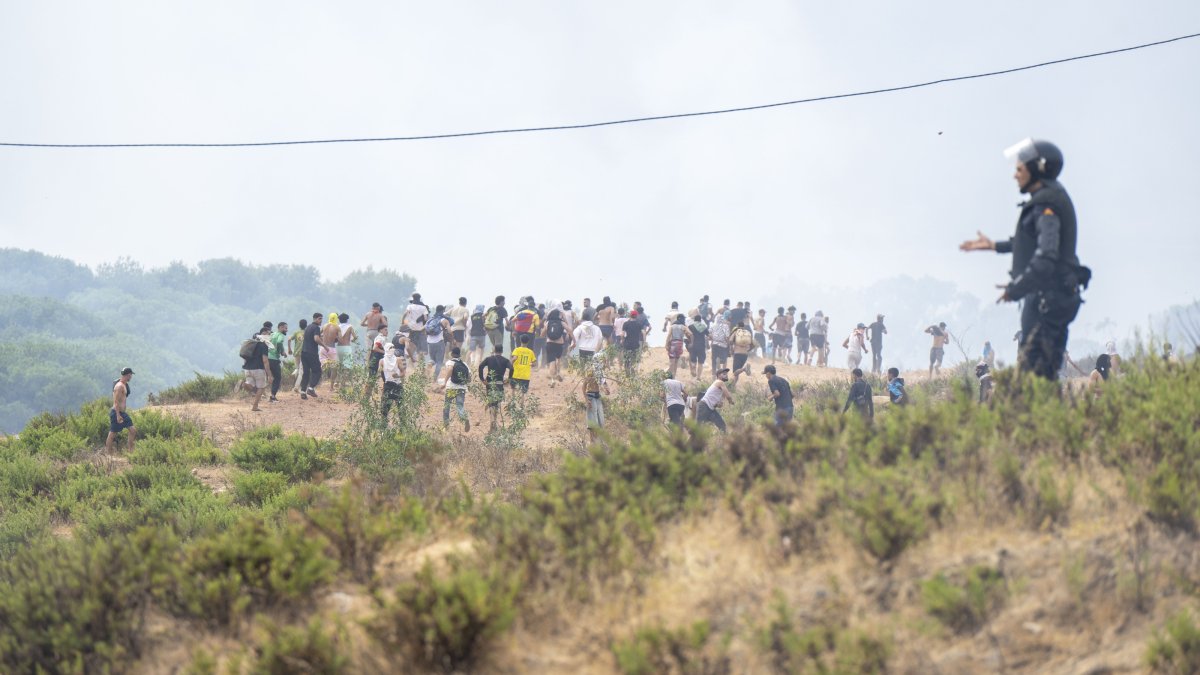 Young men who returned from Spain gather at the Bab Sebta border crossing near Fnideq, Morocco, July 31, 2026. (EPA Photo)