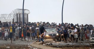 People gather at the site of clashes near Fnideq, on the Morocco-Spain border, July 31, 2026. (AFP Photo)