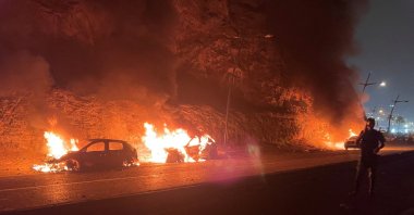 Vehicles burn as migrants wait for a chance to cross to the Spanish enclave of Ceuta, Fnideq, Morocco, July 31, 2026. (Reuters Photo)