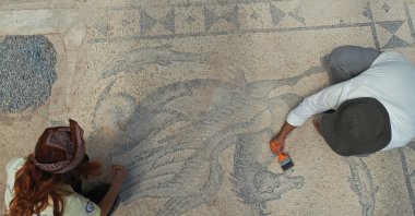 Experts work on a Roman-era floor mosaic at the ancient city of Tralleis, Aydın, western Türkiye, July 7, 2026. (AA Photo)
