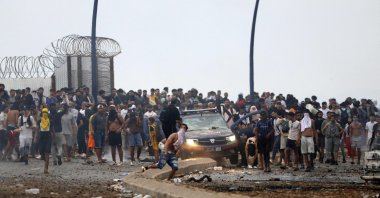 People gather at the site of clashes near Fnideq, on the Morocco-Spain border, July 31, 2026. (AFP Photo)