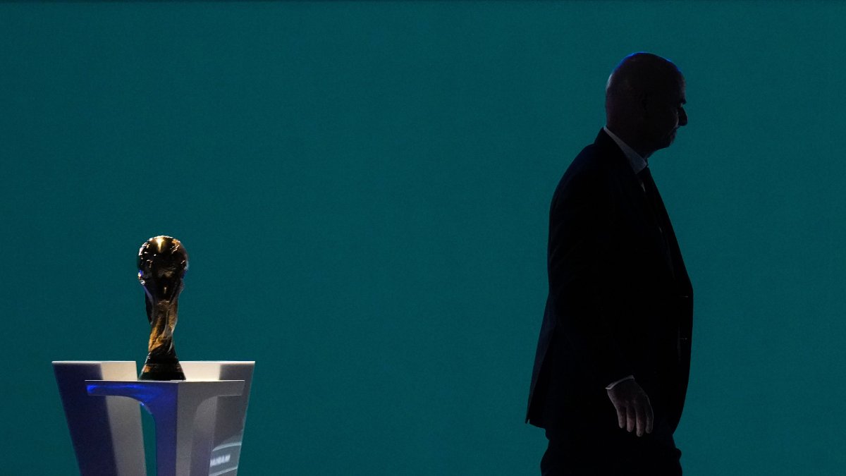 FIFA President Gianni Infantino is silhouetted as he walks past the World Cup trophy after addressing the 76th FIFA Congress, Vancouver, U.S., April 30, 2026. (AP Photo)