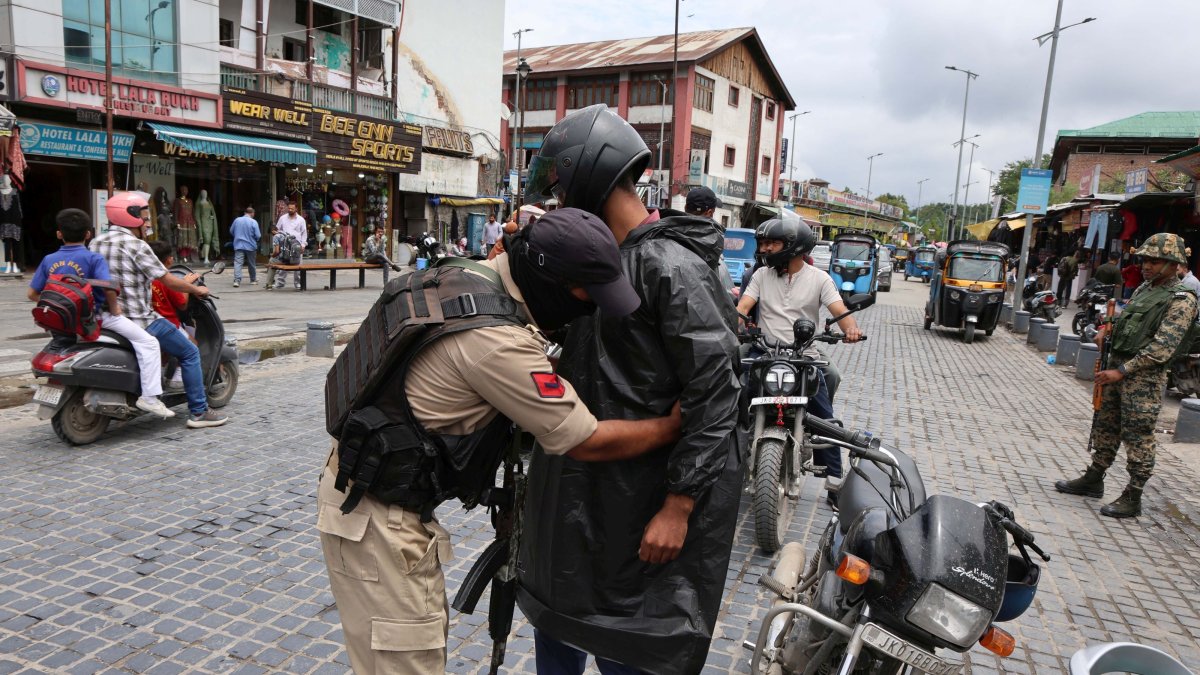 An Indian police officer frisks a man during a search operation, Srinagar, Indian Kashmir, Aug. 1, 2026. (EPA Photo)